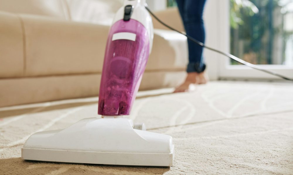 Woman vacuum cleaning carpet